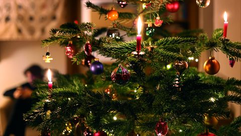 Ein geschmückter Weihnachtsbaum mit brennenden Kerzen