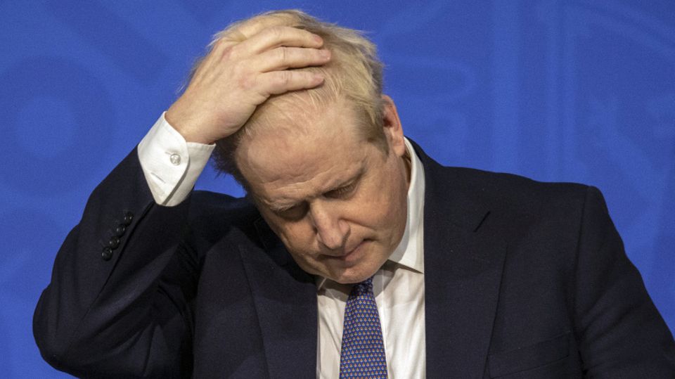 Der britische Premier Boris Johnson fasst sich während einer PK mit der Hand an den Kopf