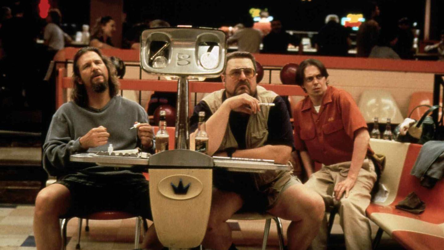 Drei Männer sitzen auf einer Bowlingbahn