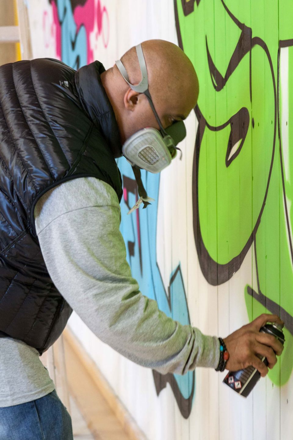 Cope2 sprayt auf eine Turnhallenwand