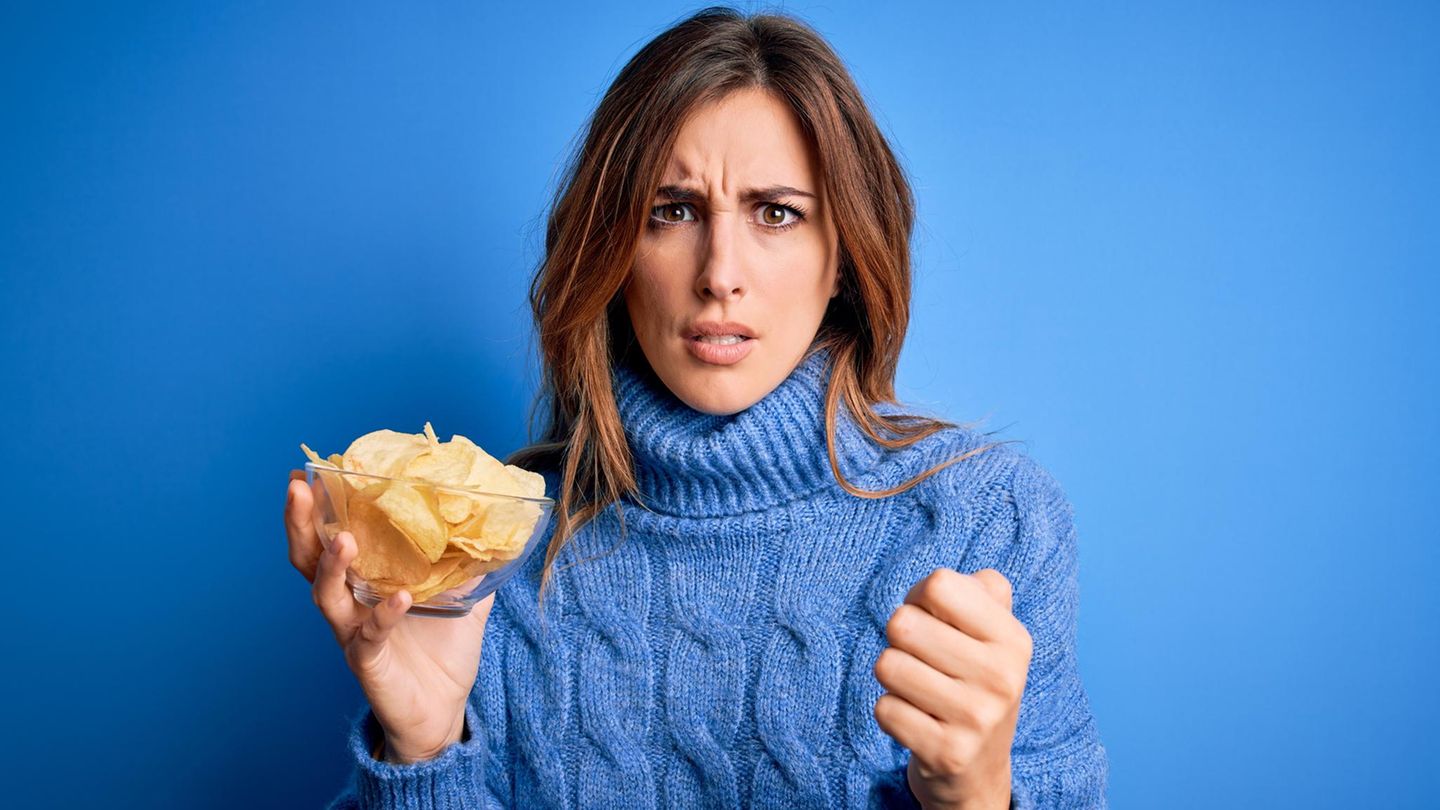 Eine Frau hält eine Schüssel mit Chips in der Hand