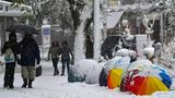 Mit Regenschirmen schützen sich die Bewohner Athens vor dem Schneefall.