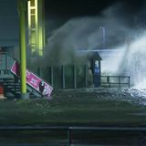 Die Gischt der aufgepeitschten Nordsee überflutet bei Sturm den Fähranleger Dagebüll