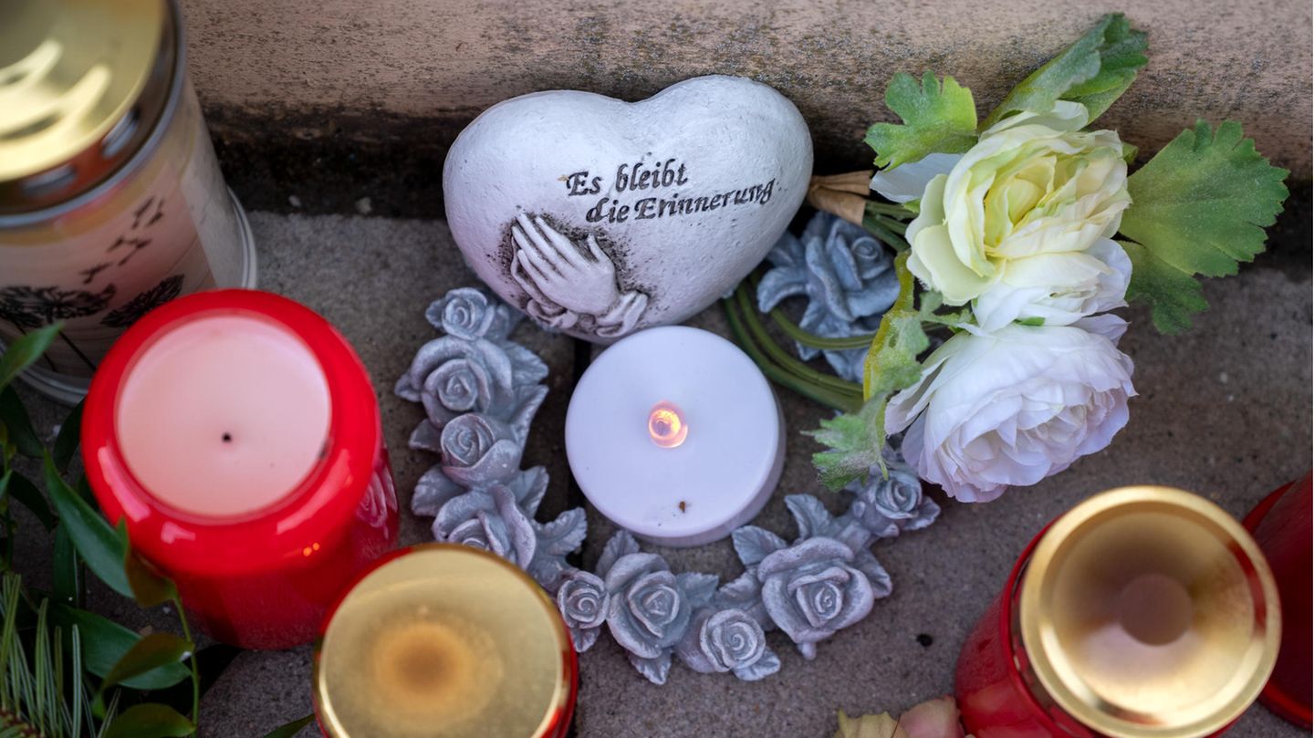 Blumen und Kerzen liegen vor der Polizeiinspektion in Kusel zum Gedenken