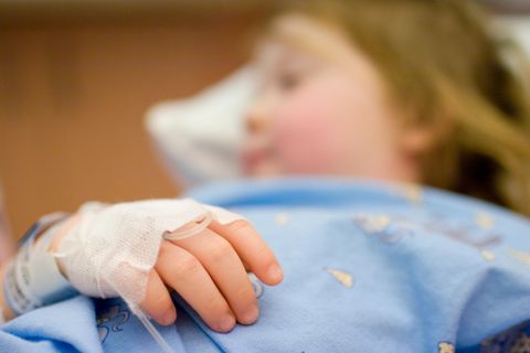 Ein kleiner Junge liegt in einem Krankenhausbett