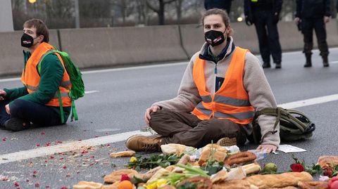 Klimaaktivist sitzt auf der Fahrbahn der Autobahn A100