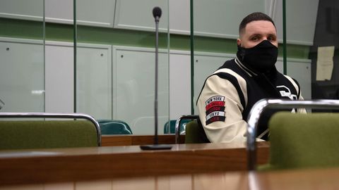 Rapper Fler sitzt in einem Gerichtssaal.