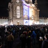 Teilnehmer stehen während einer Kundgebung auf dem Neumarkt in Dresden