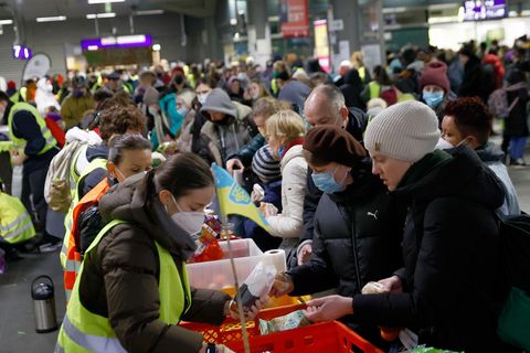 Helfer verteilen Lebensmittel an Menschen, die vor dem Krieg in der Ukraine fliehen, am Hauptbahnhof in Berlin
