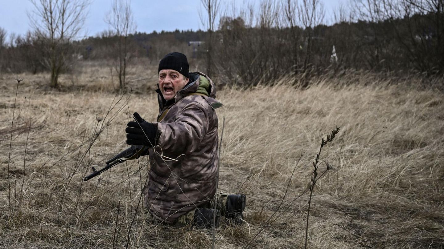 Ein Soldat in einer Graslandschaf kniet und schreit