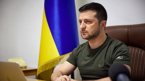 Der Präsident der Ukraine Wolodymyr Selenskyj sitzt an einem Tisch