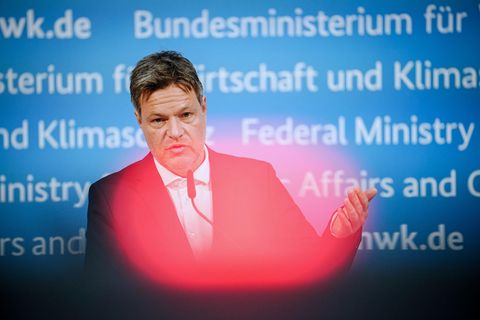 Ein weißer Mann in Anzug steht vor einer blauen Wand mit Schriftzügen "Bundesministerium für Wirtschaft und Klimaschutz"