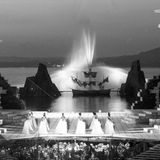 Säulen stehen am Rand der Bühne der Bregenzer Festspiele. Im Hintergrund speit eine Fontäne Wasser. Aufnahme von 1963