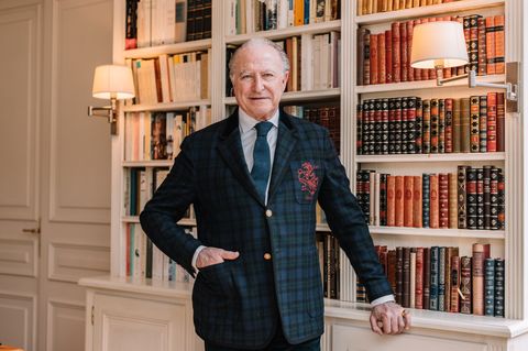 Alberto Morillas steht vor einem Bücherregal und schaut in die Kamera