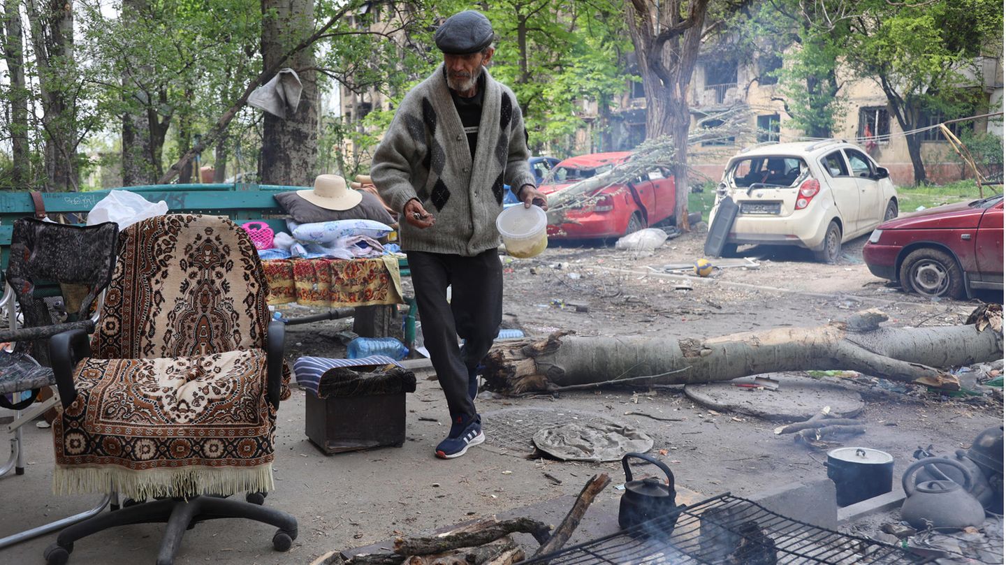 Mann kocht auf Straße in Mariupol