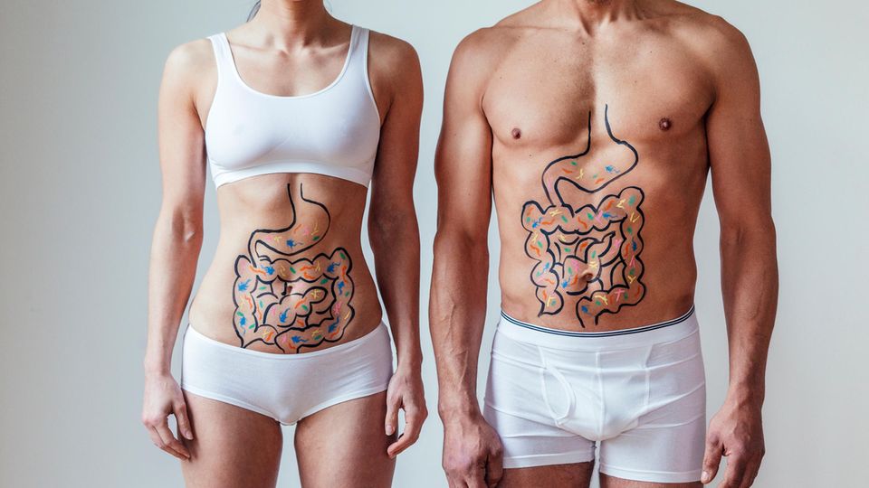 Eine Frau und ein Mann mit aufgezeichnetem Darm auf dem nackten Bauch