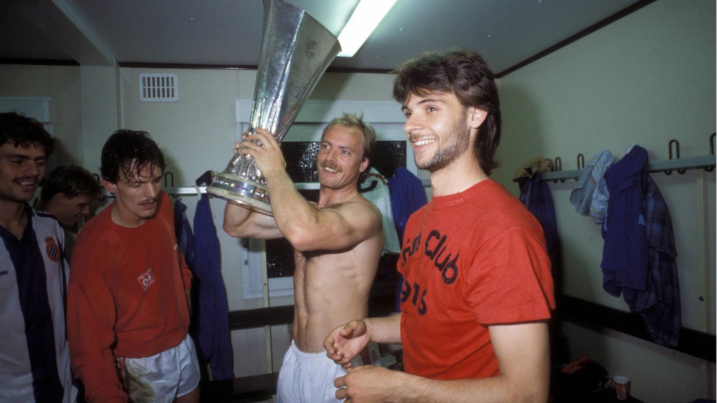 1987/88: Bayer Leverkusen sieht nach dem 0:3 bei Espanyol Barcelona schon wie der Verlierer aus. Doch im Rückspiel gleichen Tita, Götz und Cha aus. Im Elfmeterschießen versagen den Spaniern die Nerven - gleich drei Schützen vergeben. So jubelt am Ende die Werkself, hier mit Pierre de Keyser, Klaus Täuber mit dem Pott in den Händen, Erich Seckler und Falko Götz im Espanyol-Trikot in der Kabine.