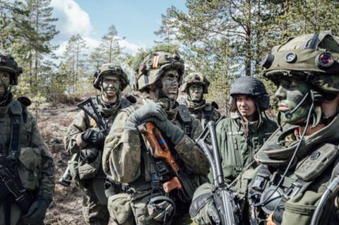 Finnische Soldaten üben den Krieg im bewaldeten Gebiet.