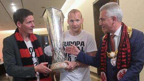 Peter Feldmann nimmt Eintracht-Trainer Oliver Glasner und Kapitan Sebastian Rode den Pokal ab