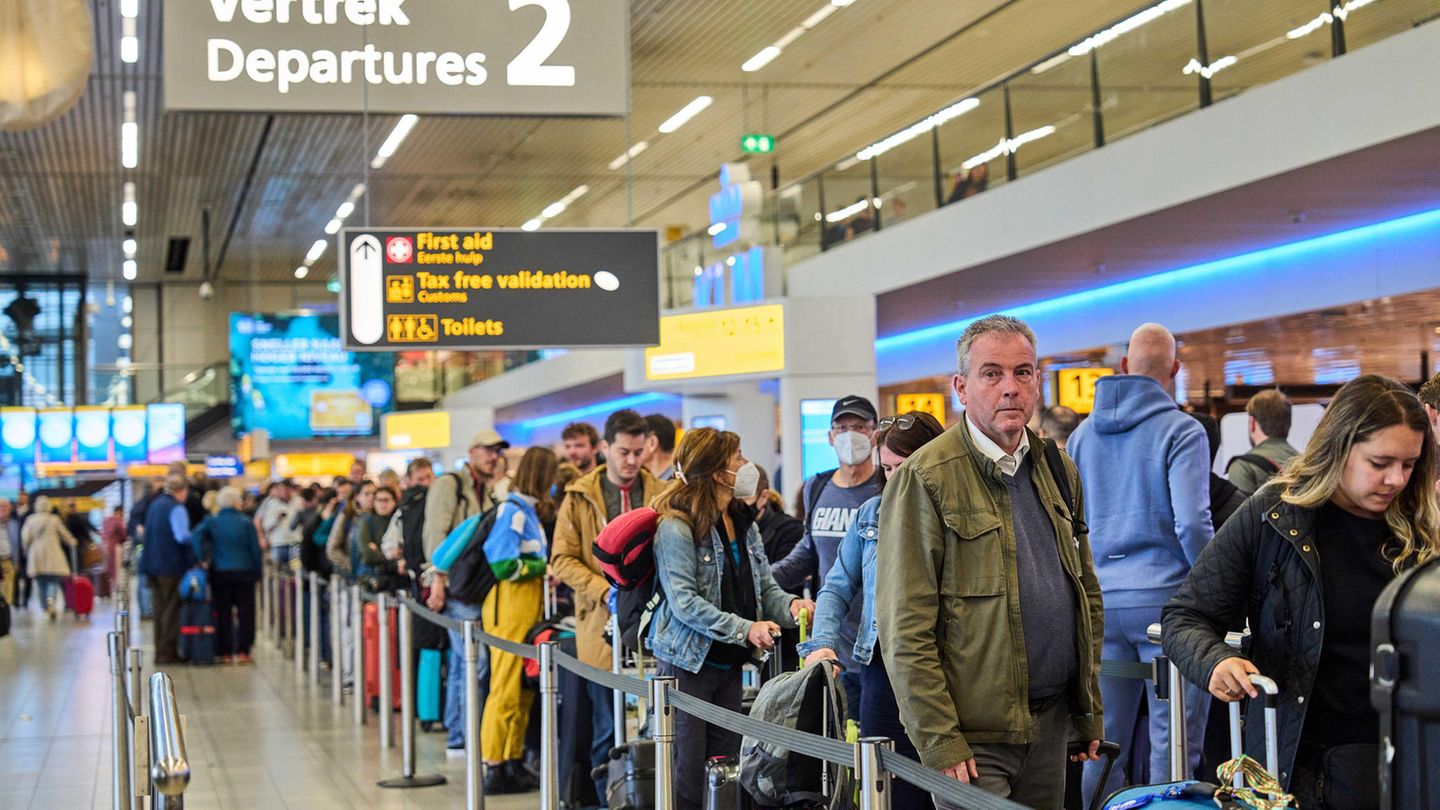 Passengers in a queue at Amsterdam Airport