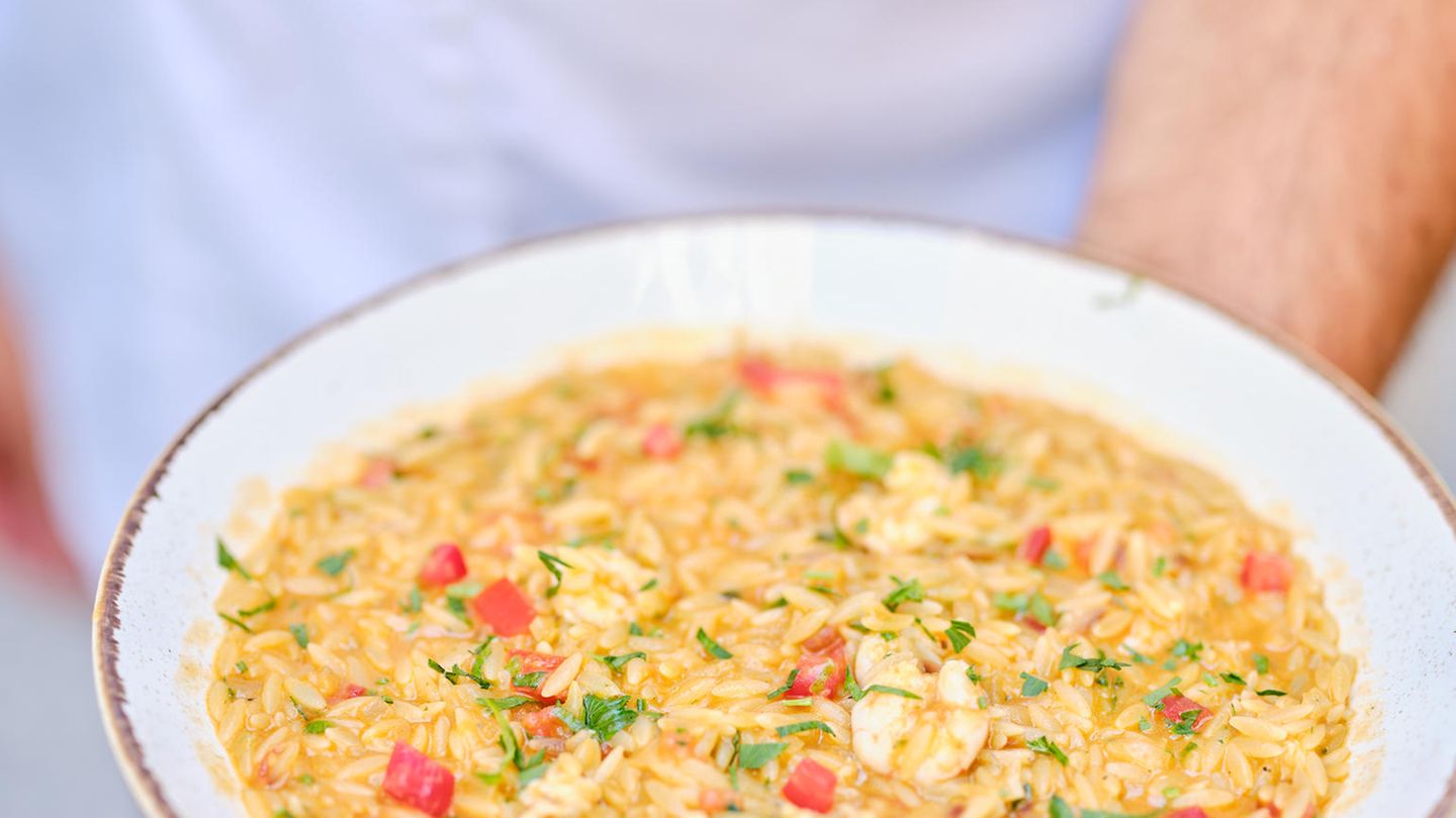 Orzo-Pasta mit Garnelen – Kritharóto me garídes      Zutaten:  1 Stange Lauch, 1 rote Spitzpaprika, 1 Zwiebel, 1 Knoblauchzehe, 4 EL Olivenöl, 50 g Butter, 500 g küchenfertige Garnelen, 500 g Orzo-Pasta, 1,5 l heißer Fischfond, 100 ml Weißwein, 400 g geriebene Tomaten, Salz, frisch gemahlener schwarzer Pfeffer  Zum Servieren  2 EL gehackte Petersilie      Zubereitung:      Den Lauch in dünne Ringe schneiden. Die Paprika würfeln. Zwiebel und Knoblauch fein hacken.  Olivenöl und Butter in einer tiefen Pfanne erhitzen. Zwiebel, Knoblauch, Lauch und Paprika hineingeben und etwas braten. Die Garnelen etwa 2 Minuten mitbraten, dann aus der Pfanne nehmen und warm beiseitestellen.  Anschließend die Orzo-Pasta hinzugeben, die Temperatur erhöhen und alles umrühren. Etwas Fischfond angießen und warten, bis die Nudeln die Flüssigkeit aufgenommen haben. Alles mit dem Weiß- wein ablöschen und die geriebenen Tomaten dazugeben.  Unter ständigem Rühren den restlichen Fischfond nach und nach hinzufügen. Wenn die Nudeln nach etwa 15 Minuten gar sind, die Garnelen unterrühren.  Die Pasta mit Salz und Pfeffer würzen, in tiefen Tellern anrichten, mit Petersilie garnieren und servieren.