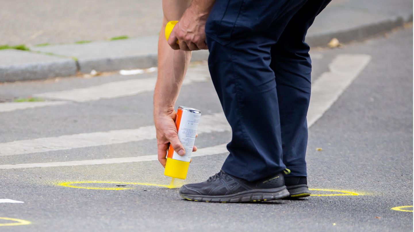 Nach einem tödlichen Zwischenfall werden auf der abgesperrten Straße Spuren markiert.