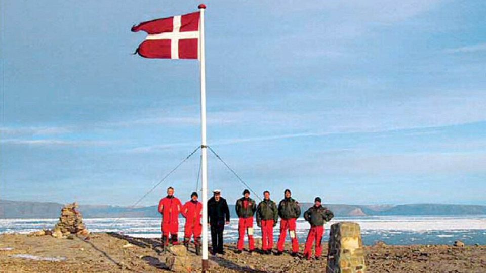 Dänische Soldaten posieren mit einer dänischen Flagge auf der Hans-Insel