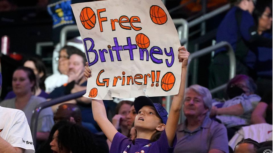 Brittney Griner jailed in Russia - a basketball superstar becomes a political issue Fans with placards celebrating Brittney Griner's release