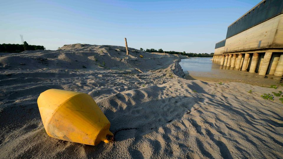 A buoy lies on the bed of the Po in Boretto instead of floating in the water as usual.  Due to extreme drought, many communities in Italy had to throttle or shut down the drinking water supply at night