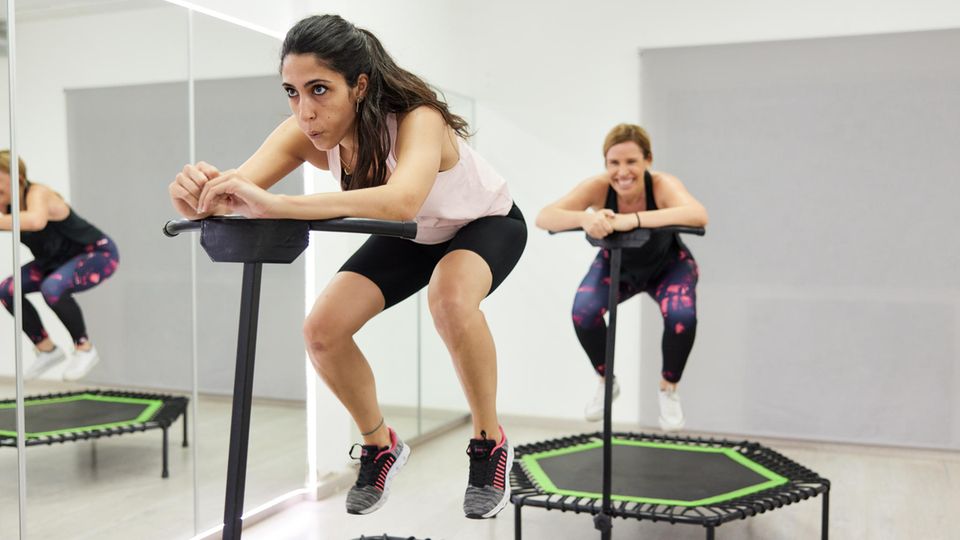 Jumping Fitness: Zwei junge Frauen trainieren auf einem Fitness-Trampolin