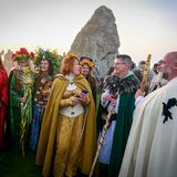 Menschen in Verkleidungen stehen in Stonehenge