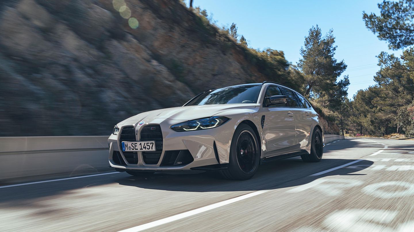 The BMW M3 Touring drives on a road