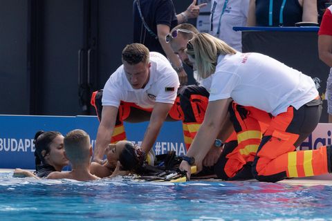 Die Synchronschwimmerin Anita Alvarez wird aus dem Wasser gezogen und von Helfern auf eine Trage gelegt