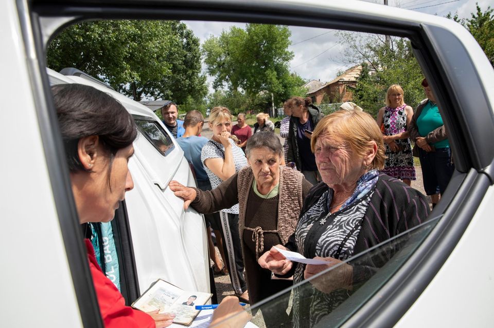 Helfer verteilen Lebensmittelspenden Helfer verteilen Lebensmittelspenden