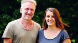 Mann und Frau vor grünen Büschen