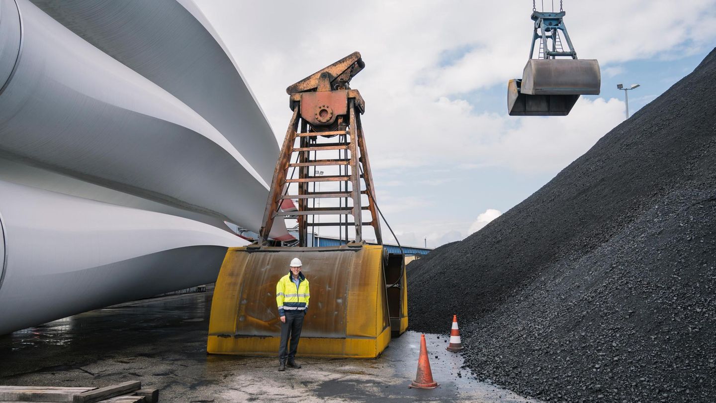 Frank Schnabel zwischen Windkraftrotoren und Kohlehalde