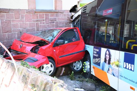Heidelberg: Ein zerstörtes Auto und ein Linienbus stehen nach einem Unfall an einer Hauswand