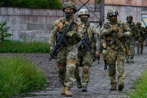 Russische Soldaten gehen im Mai durch einen zerstörten Bereich des Iljitsch Eisen- und Stahlwerks Mariupol