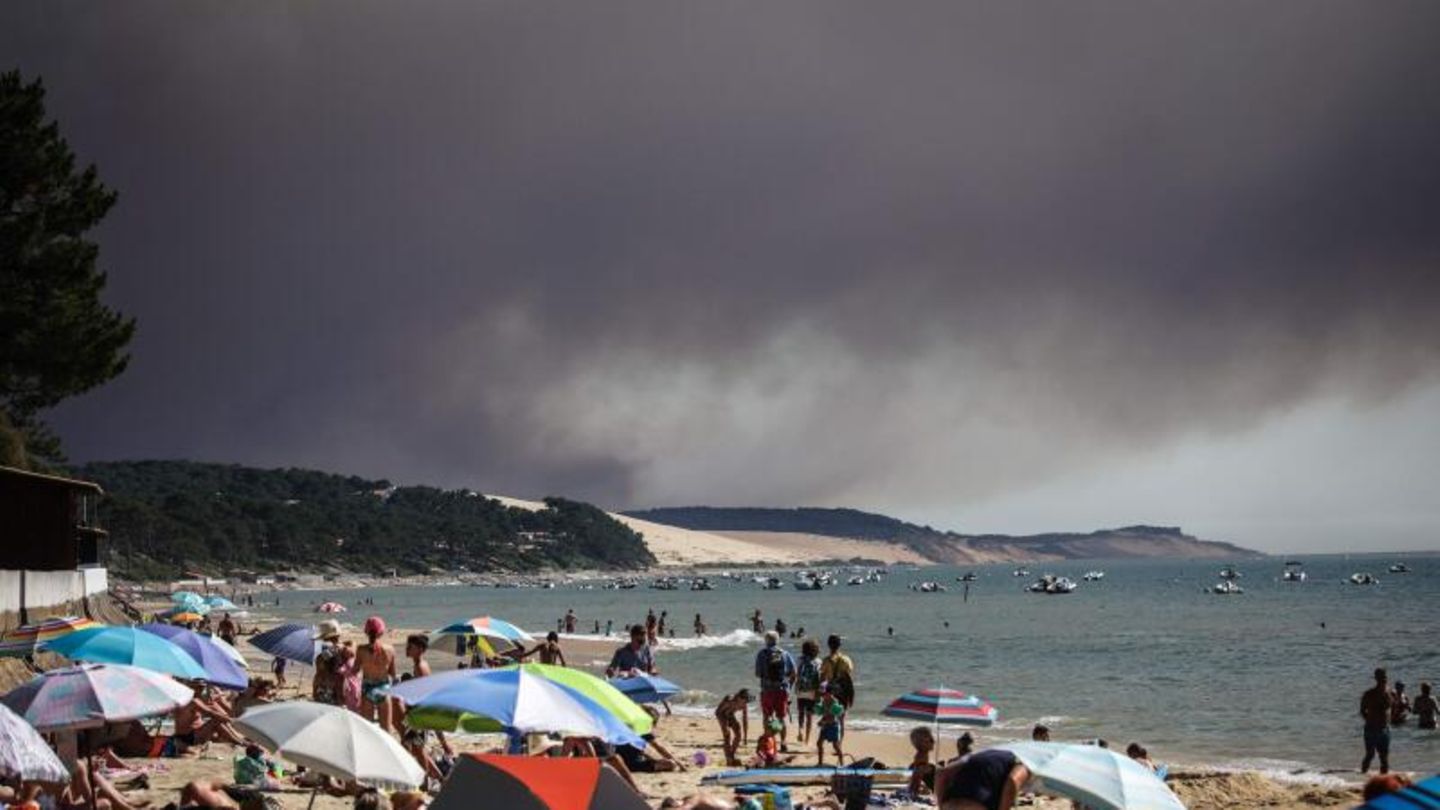 Hitzewelle in Frankreich: Dunkle Wolken über einem Strand durch einen Waldbrand