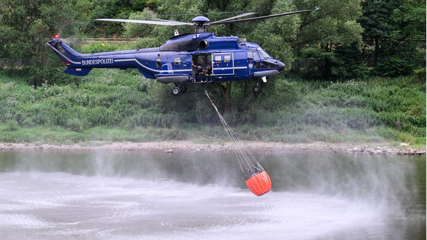 Blauer Hubschrauber mit Wassersack