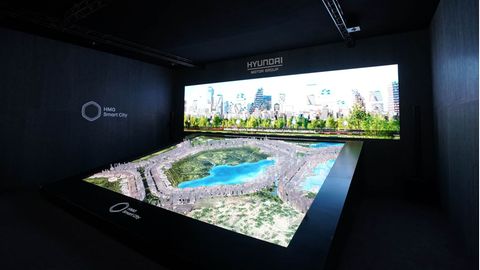 Eine Grafik zeigt eine Stadt umgeben von Grünflächen