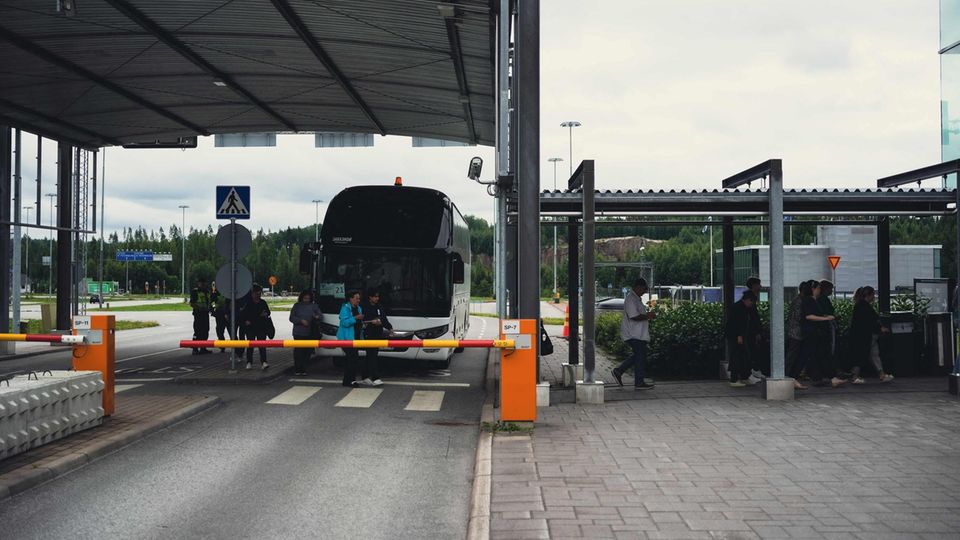 Russian tourists arrive by bus at the Nuijamaa border crossing