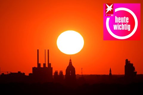 Die Sonne geht hinter dem Gaskraftwerk Linden und dem Neuen Rathaus unter. Das Foto wurde mit extremer Telebrennweite aus knapp acht Kilometer Entfernung vom Kronsberg am Stadtrand Hannovers aufgenommen.