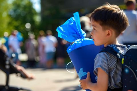 Zum Schulanfang trägt ein Erstklässler eine Schultüte