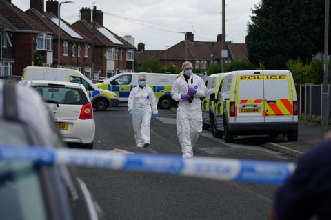 Beamte der Spurensicherung in der Nähe des Tatorts in Liverpool, England, wo ein neunjähriges Mädchen tödlich erschossen wurde