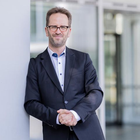 Klaus Müller steht nach einem Interview vor seiner Behörde in Bonn.