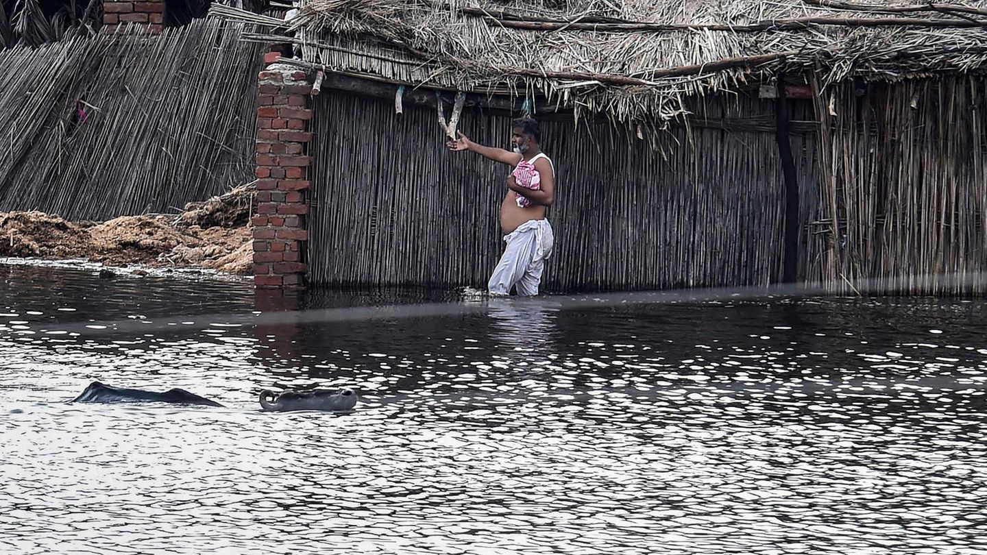 In der Sindh-Provinz im Südosten des Landes watet ein Bewohner durch das Wasser. Der pakistanische Premierminister Shehbaz Sharif verspricht eine finanzielle Soforthilfe von über 50 Millionen Euro für die Opfer der Flut.