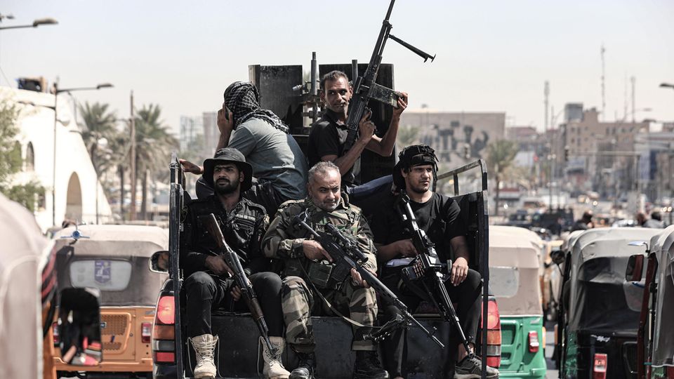 Iraq, Baghdad: Armed members of Saraya al-Salam ("Peace Company"), the military wing of Shia cleric Al-Sadr, ride in a vehicle during clashes with Iraqi security forces in the Green Zone