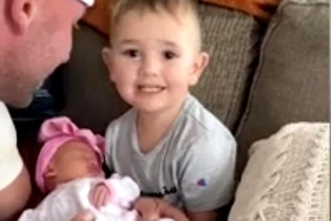 Ein besonderer Moment: Ein Kleinkind lernt seine kleine Schwester kennen