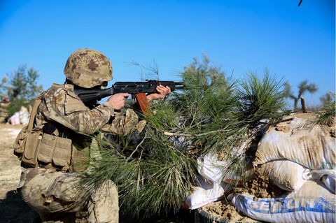 Ein Soldat der Dschihadistengruppe Hajat Tahrir al-Scham hält ein Gewehr in den Händen